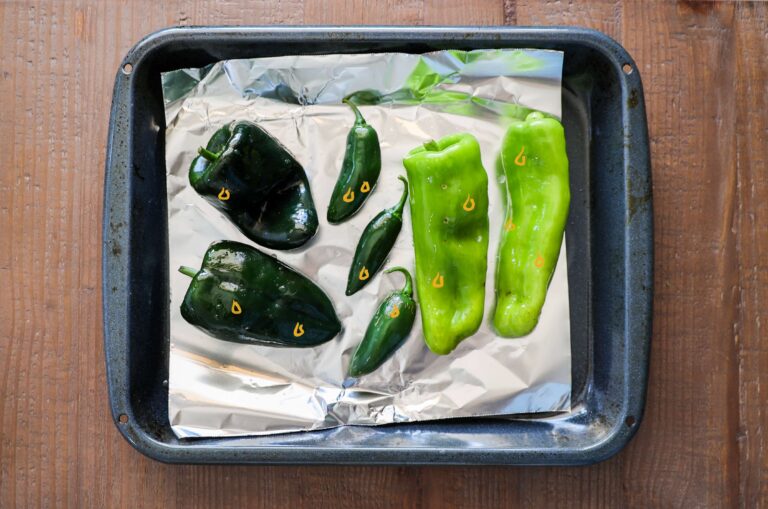 oiled up peppers on baking pan