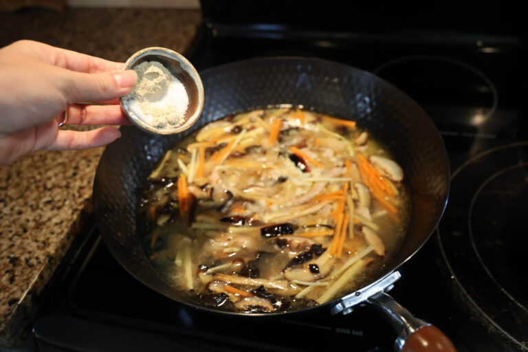 pour spices into wok
