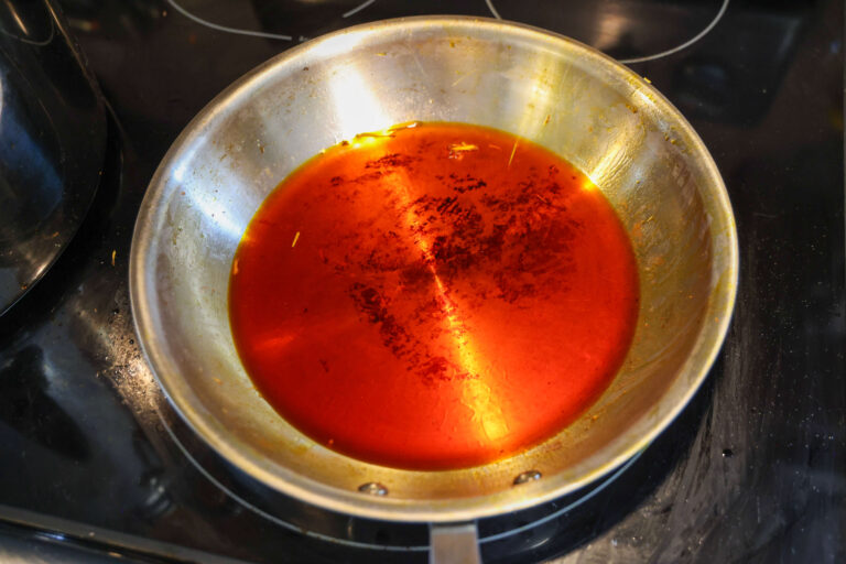 discard spent seeds, clear red oil remains